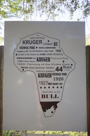 A historical signboard detailing the history of Kruger National Park, including its founding in 1898, expansion, and significant events. - Doringpoort Safari Lodge (Nkomazi)