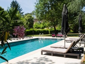 Seasonal outdoor pool, a heated pool, pool umbrellas, sun loungers