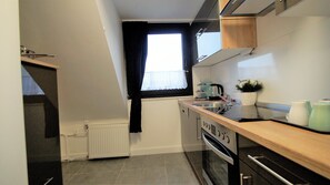 Deluxe Apartment, City View | Private kitchen | Full-size fridge, oven, dishwasher, coffee/tea maker