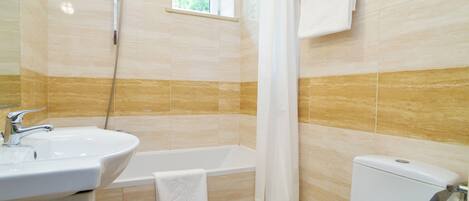 A bathroom with a sink, bathtub, and toilet.