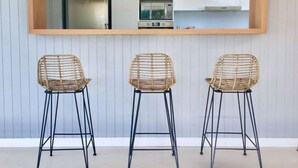 Three wicker chairs with metal legs against a wall with a large mirror above them. - Best Villa in José Ignacio - Pinar del Faro - Brand New House (Departamento de Maldonado)
