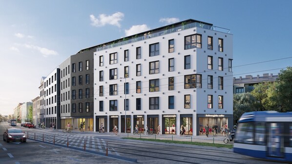 Situated in an urban setting, this building offers a mix of window styles and balconies with glass railings.