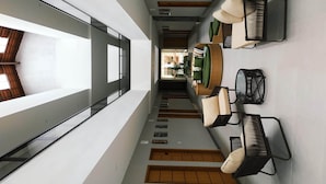 Un interior moderno con una larga mesa de comedor, varias sillas y vistas al exterior.