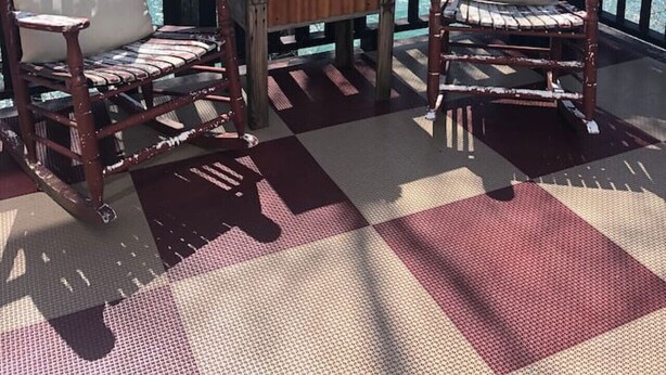 A deck with two wooden chairs and a small table with a vase of yellow flowers. - Arabian nights Luxury suite, Glamping tent (Irwin)