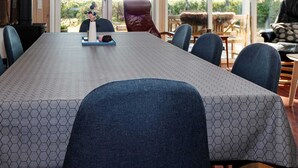 A conference room with a long table, hexagonal patterned tablecloth, and modern chairs. - Cozy Holiday Home in Hadsund near Sea (Hadsund)