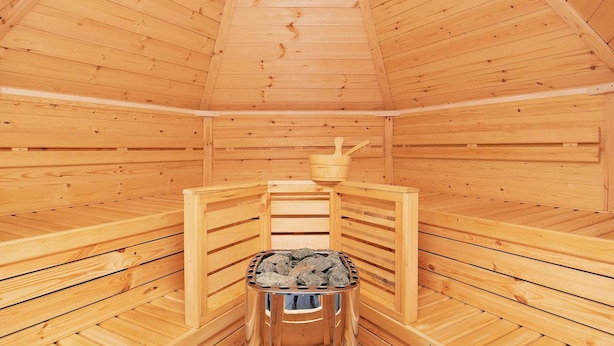 A sauna with wooden walls and a bench. - 7 Person Holiday Home in Jerup (Strandby)