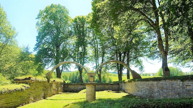 An ancient stone bridge with arches, surrounded by lush greenery and trees. - 4 Person Holiday Home in Axvall (Axvall)