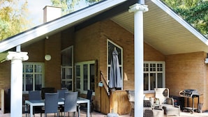 A covered patio with outdoor furniture, a grill, and a pergola. - 5 Star Holiday Home in Hadsund (Hadsund)