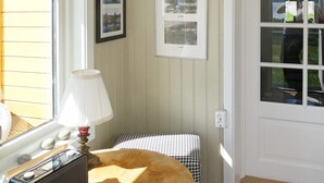 A room with a bed, a lamp, a framed photo collage on the wall, and a window with blinds. - 7 Person Holiday Home in Skutvik (Hamaroy)