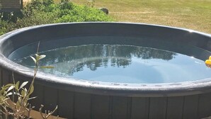 A large, round, outdoor hot tub with a metal rim and a smooth, reflective surface. - 6 Person Holiday Home in Nykobing M (Nykobing Mors)