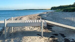 A wooden boardwalk leading to a sandy beach with a clear view of the ocean. - 6 Person Holiday Home in Nykobing M (Nykobing Mors)