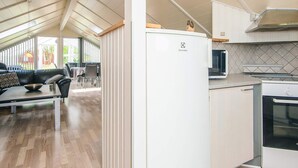A modern kitchen with white cabinets, a built-in microwave, and a stove. - 8 Person Holiday Home in Hemmet (Hemmet)