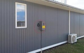 A building with a window and a utility box on the side. - 6 Person Holiday Home in Lemvig (Lemvig)
