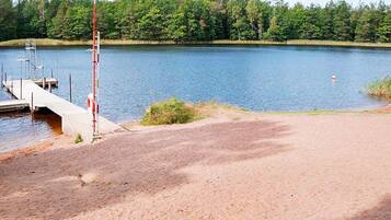 A lakeside area with a dock and a lifebuoy.