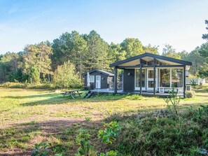 A cabin with a porch, a picnic table, and a deck. - Elegant Holiday Home in Nordjylland near Sea (Læsø)