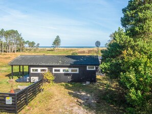 A small cabin with a metal roof, a satellite dish, and a view of the sea. - Elegant Holiday Home in Nordjylland near Sea (Læsø)