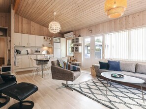 A modern interior with a dining area, kitchen, and seating space.