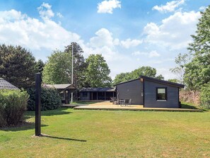 A modern house with a patio area and a small deck. - 8 Person Holiday Home in Vaeggerlose (Vaeggerlose)