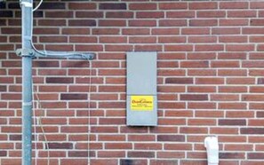 A brick wall with a utility box and a metal pole. - 8 Person Holiday Home in Blavand (Blavand)
