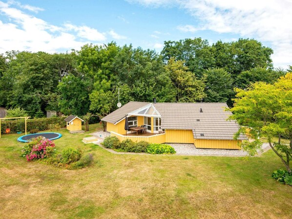 A two-story house with a covered patio and a swimming pool. - 4 Star Holiday Home in Sydals (Sydals)