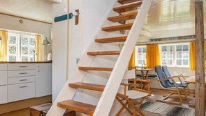 A spiral staircase with wooden steps leading to a second floor. - Traditional Holiday Home in Jutland near Sea (Fano)