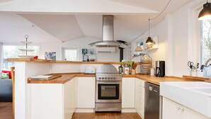 A modern kitchen with white cabinetry, a stainless steel oven, and a dishwasher. - Simplistic Holiday Home in GÃ¸rlev near Sea (Gørlev)