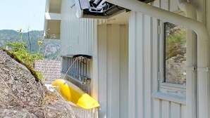 A building with a window and a yellow object attached to the exterior wall. - 6 Person Holiday Home in Brevik (Porsgrunn)