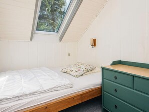 A single bed with a wooden frame, a green dresser with drawers, a wall-mounted light fixture, and a skylight. - 6 Person Holiday Home in Toftlund (Toftlund)