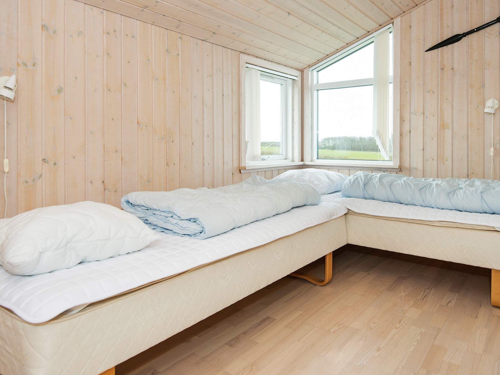 A room with wooden walls and a large window.