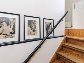 A staircase with wooden steps and a black handrail. - Holiday Home in Svendborg (Svendborg)