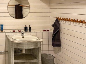 Bathroom features a sink, mirror, and towel rack.