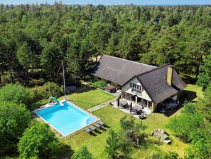 A two-story house with a swimming pool, surrounded by dense forest. - 14 Person Holiday Home in Sjaellands Odde (Sjællands Odde)