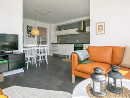 A modern living room with a television, sofa, and decorative lanterns.