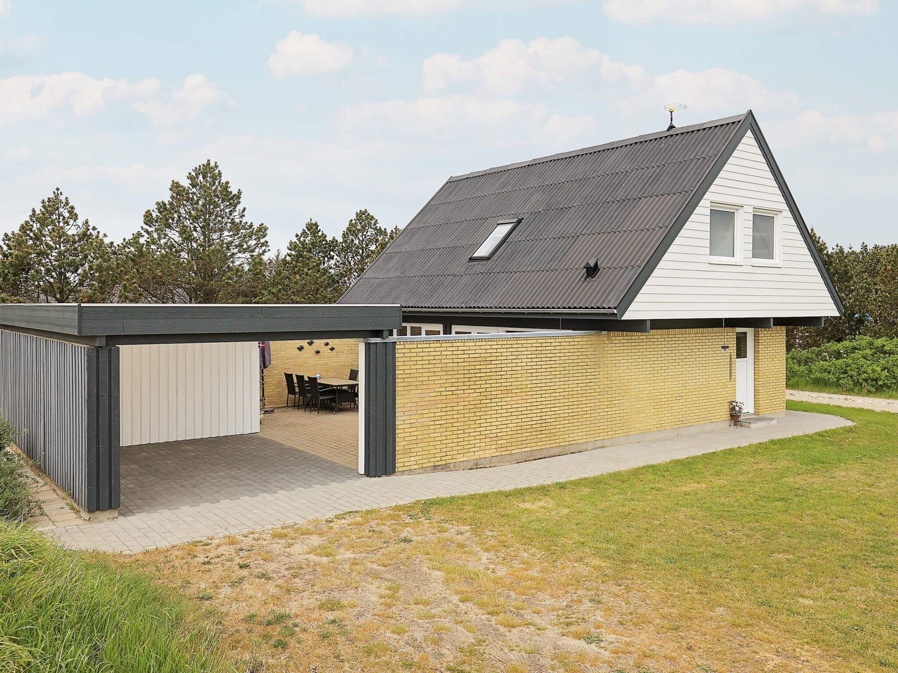 A single-story house with a covered patio area and a brick exterior.