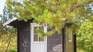 A small cabin with a white door, a window, and a wooden porch. - Luxury Retreat in Nr. Lyngby-by Traum (Lokken)