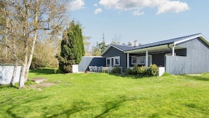 A modern two-story house with a covered porch and a well-maintained lawn. - 6 Person Holiday Home in Ebeltoft (Ebeltoft)