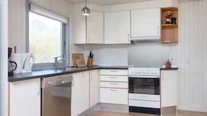 A modern kitchen with white cabinetry, a built-in oven, and a dishwasher. - 6 Person Holiday Home in Ebeltoft (Ebeltoft)