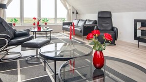 A modern living room with a glass coffee table, leather sofas, and a large window with a view. - 12 Person Holiday Home in Lemvig (Lemvig)