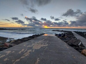 A concrete pathway leading to the sea with rocky outcrops on either side. - Spacious Holiday Home Nearby the National Park Loonse en Drunese Duinen (Hjørring)