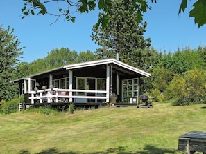 A single-story house with a porch, large windows, and a chimney. - 4 Person Holiday Home in Hojslev (Hojslev)