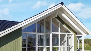 A modern house with a large glass windowed porch, a green exterior, and a sloped roof. - Splendid Holiday Home in Jutland With Whirlpool (Sydals)
