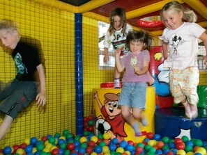 Children playing in a ball pit with colorful balls and cartoon characters on the walls. - 4 Star Holiday Home in Skaerbaek (Skaerbaek)