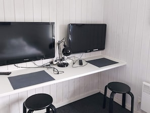 A white desk with two black monitors, a lamp, and two black stools. - Alluring Holiday Home in Hadsund near Sea (Hadsund)