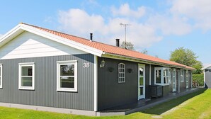 A two-story building with a grey exterior, white trim, and a red-tiled roof. - Alluring Holiday Home in Hadsund near Sea (Hadsund)