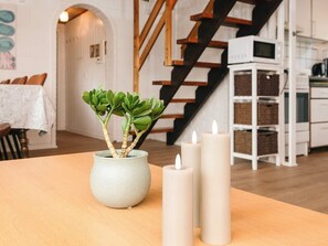 A dining area with a table, candles, and a potted plant. - Cozy Holiday Home in Hemmet near Sea (Hemmet)