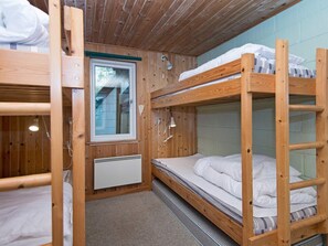 A bunk bed room with a window, a radiator, and a wooden ceiling. - Cozy Holiday Home in Hemmet near Sea (Hemmet)