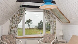 A cozy room with a window, two chairs, a table, and a lamp. - Cozy Holiday Home in Hemmet near Sea (Hemmet)