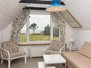 A cozy room with a window, two chairs, a table, and a lamp. - Cozy Holiday Home in Hemmet near Sea (Hemmet)