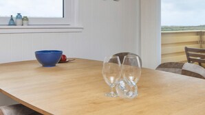 A wooden table with a blue bowl and three wine glasses. - 5 Person Holiday Home in Lemvig (Lemvig)
