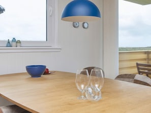 A wooden table with a blue bowl and three wine glasses. - 5 Person Holiday Home in Lemvig (Lemvig)